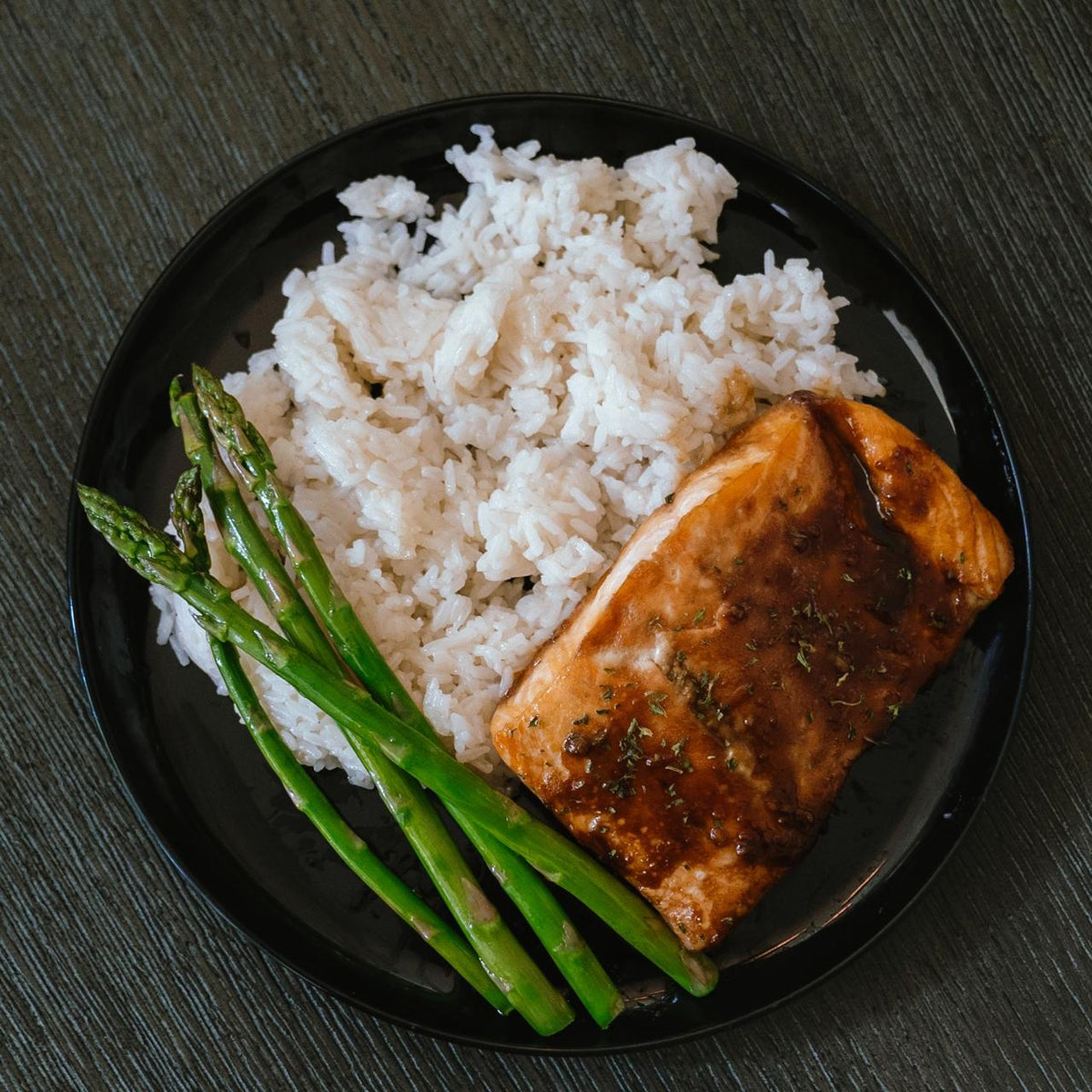 Honey glazed salmon over steamed and asparagus